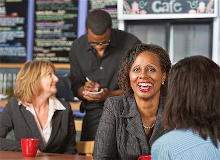 Cute laughing mature business woman with friend in cafe Stock Photo - Budget Royalty-Free & Subscription, Code: 400-07577392