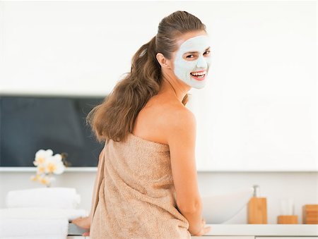 Smiling young woman wearing facial cosmetic mask Stock Photo - Budget Royalty-Free & Subscription, Code: 400-07577569