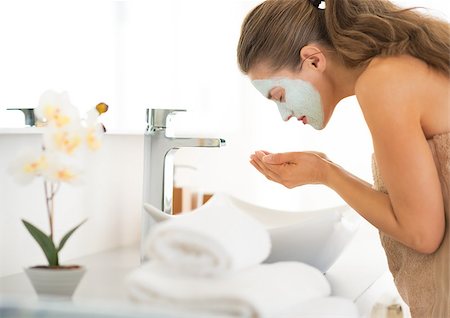 Young woman wearing facial cosmetic mask washing face Stock Photo - Budget Royalty-Free & Subscription, Code: 400-07577574