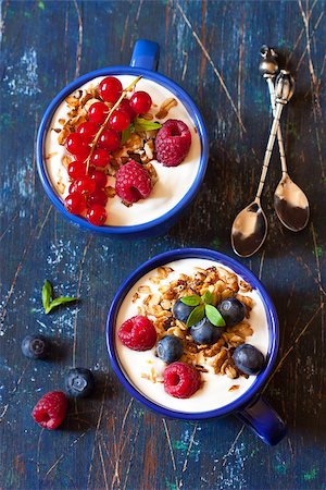 Yogurt with granola and fresh berries on an old wooden board. Stock Photo - Budget Royalty-Free & Subscription, Code: 400-07578185