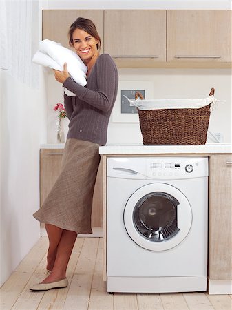 simsearch:640-03260502,k - pretty smiling girl in the laundry room l Stock Photo - Budget Royalty-Free & Subscription, Code: 400-07578251