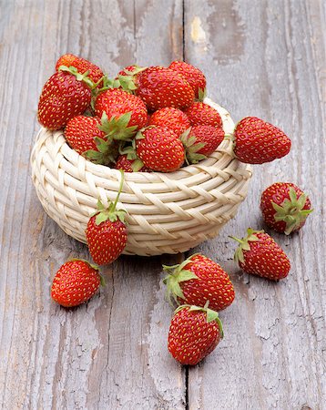 simsearch:400-08020671,k - Fresh Ripe Forest Strawberries in Wicker Bowl isolated on Rustic Wooden background Stock Photo - Budget Royalty-Free & Subscription, Code: 400-07579646