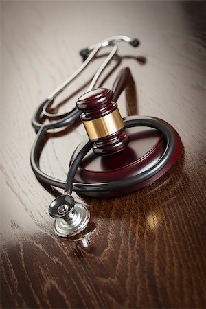 simsearch:400-05358699,k - Gavel and Stethoscope on Reflective Wooden Table. Photographie de stock - Aubaine LD & Abonnement, Code: 400-07579721