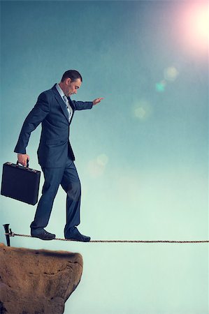 separation anxiety - balancing businessman starting out on a tightrope Stock Photo - Budget Royalty-Free & Subscription, Code: 400-07579979