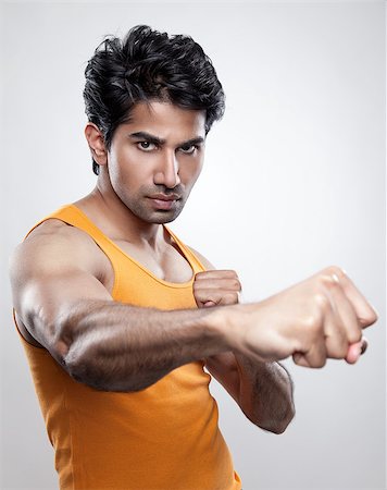 simsearch:400-04599868,k - Handsome Indian man giving a knockout punch Foto de stock - Super Valor sin royalties y Suscripción, Código: 400-07570328