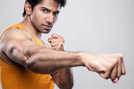simsearch:400-08333281,k - Handsome Indian man giving a knockout punch Stock Photo - Budget Royalty-Free & Subscription, Code: 400-07570329