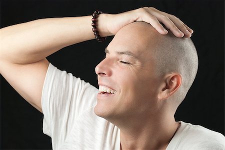 Close-up of a man feeling his newly shaved head. Stock Photo - Budget Royalty-Free & Subscription, Code: 400-07570599