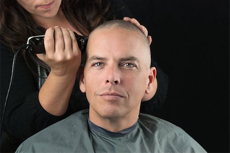 Close-up of a hair stylist using clippers to shave her Clients head. Stock Photo - Budget Royalty-Free & Subscription, Code: 400-07570602