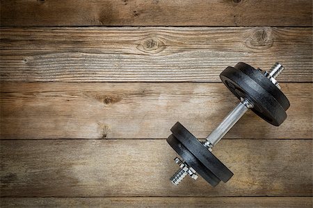 simsearch:400-07620929,k - exercise concept - iron dumbbell on a grunge wooden deck Stock Photo - Budget Royalty-Free & Subscription, Code: 400-07571136