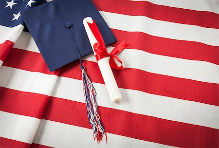 school flag - Graduation Cap with Tassel and Red Ribbon Wrapped Diploma Resting on American Flag. Stock Photo - Budget Royalty-Free & Subscription, Code: 400-07571215