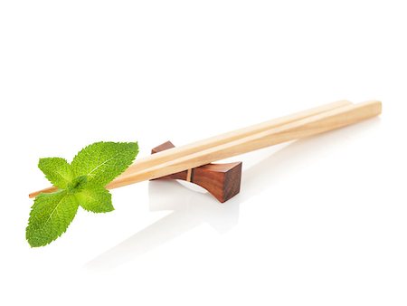 simsearch:400-07719212,k - Sushi chopsticks with mint leaves. Isolated on white background Fotografie stock - Microstock e Abbonamento, Codice: 400-07571519