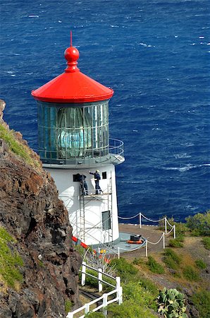 Two workmen paint the exterior of the Makapuu Point Lighthouse on the Island of Oahu, Hawaii.  Azure waters frame cliff and light. Stock Photo - Budget Royalty-Free & Subscription, Code: 400-07571853