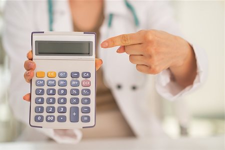 simsearch:400-07099823,k - Closeup on medical doctor woman pointing on calculator Stock Photo - Budget Royalty-Free & Subscription, Code: 400-07572116