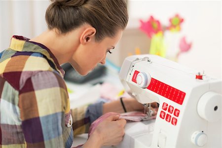 Seamstress working with sewing machine. rear view Stock Photo - Budget Royalty-Free & Subscription, Code: 400-07572192