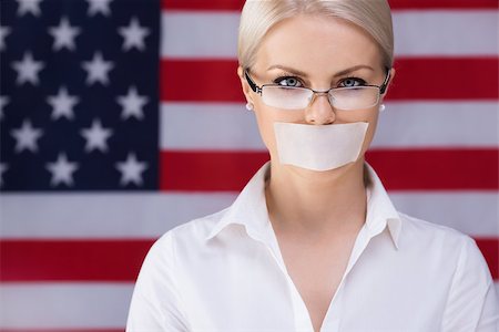 Young girl with her â??â??mouth sealed over American flag background Stock Photo - Budget Royalty-Free & Subscription, Code: 400-07572212