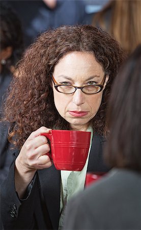 Offended businesswoman with friend holding coffee cup Stock Photo - Budget Royalty-Free & Subscription, Code: 400-07573258