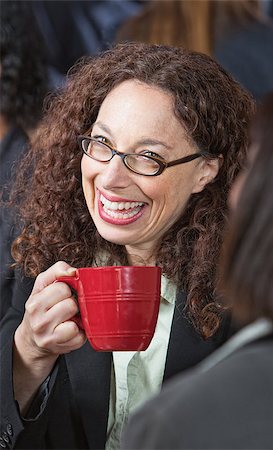 simsearch:400-07553657,k - Close up of business woman with red mug laughing Stockbilder - Microstock & Abonnement, Bildnummer: 400-07573262