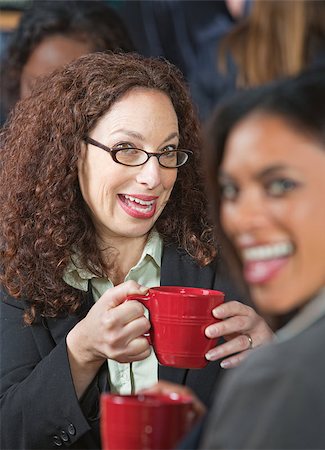 simsearch:400-07553657,k - Two pretty business women laughing together in cafe Stockbilder - Microstock & Abonnement, Bildnummer: 400-07573263