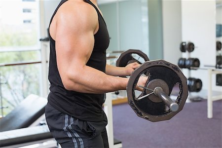 simsearch:400-06208099,k - Muscular bodybuilder lifting heavy black barbell weight at the gym Photographie de stock - Aubaine LD & Abonnement, Code: 400-07584021