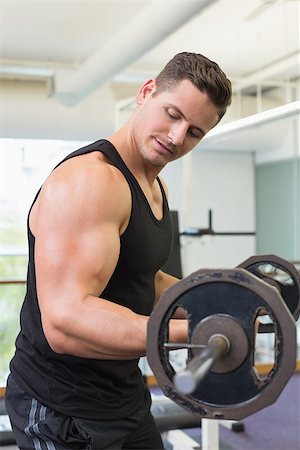 simsearch:400-06208099,k - Muscular bodybuilder lifting heavy black barbell weight at the gym Photographie de stock - Aubaine LD & Abonnement, Code: 400-07584022