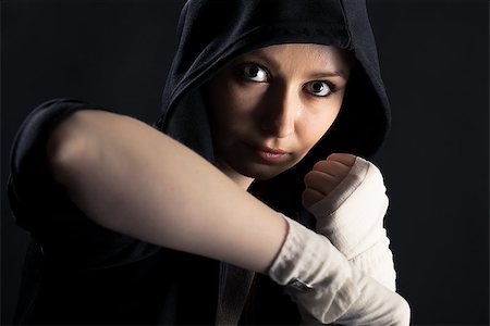 face boxing - On a black background girl with a fighting stance Stock Photo - Budget Royalty-Free & Subscription, Code: 400-07584611