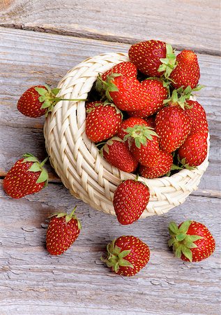 simsearch:400-08020671,k - Fresh Ripe Forest Strawberries in Wicker Bowl isolated on Rustic Wooden background. Top View Stock Photo - Budget Royalty-Free & Subscription, Code: 400-07580165