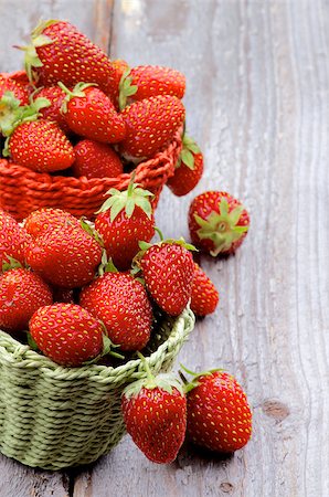 simsearch:400-08020671,k - Fresh Ripe Forest Strawberries in Red and Green Wicker Baskets closeup on Rustic Wooden background Stock Photo - Budget Royalty-Free & Subscription, Code: 400-07580482