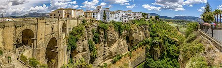 simsearch:400-07209028,k - Ronda Panoramic view over Puente Nuevo ("New Bridge") The newest and largest of three bridges that span the 120-metre (390 ft)-deep chasm that carries the Guadalevín River and divides the city of Ronda, in southern Spain. Built between 1759-1793, the architect was José Martin de Aldehuela. Stock Photo - Budget Royalty-Free & Subscription, Code: 400-07580711