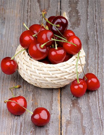 simsearch:400-08020671,k - Red Ripe Sweet Cherries in Wicker Bowl isolated on Rustic Wooden background Stock Photo - Budget Royalty-Free & Subscription, Code: 400-07580875