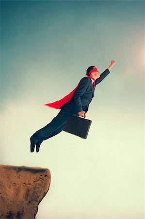 superhero businessman taking flight from a cliff ledge Stock Photo - Budget Royalty-Free & Subscription, Code: 400-07580896