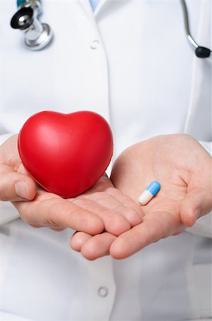 drugs heart - Female doctor showing a red heart and a blue pill Stock Photo - Budget Royalty-Free & Subscription, Code: 400-07580900