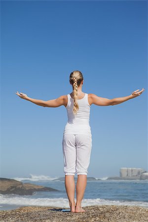Blonde woman standing on beach on rock on a sunny day Stock Photo - Budget Royalty-Free & Subscription, Code: 400-07581045
