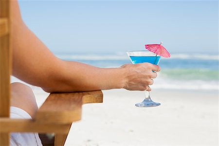 sunbed and cocktail - Woman sitting in deck chair with a cocktail at the beach on a sunny day Stock Photo - Budget Royalty-Free & Subscription, Code: 400-07581091