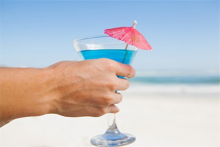 sunbed and cocktail - Woman sitting in deck chair with a cocktail at the beach on a sunny day Stock Photo - Budget Royalty-Free & Subscription, Code: 400-07581093