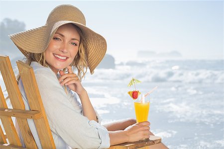 sunbed and cocktail - Smiling blonde relaxing in deck chair by the sea holding cocktail on a sunny day Stock Photo - Budget Royalty-Free & Subscription, Code: 400-07581655