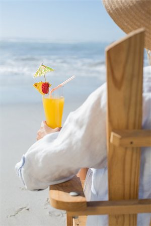 sunbed and cocktail - Woman relaxing in deck chair by the sea holding cocktail on a sunny day Stock Photo - Budget Royalty-Free & Subscription, Code: 400-07581653
