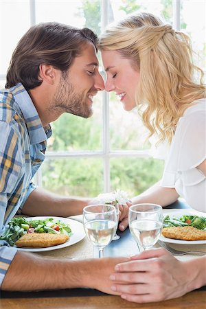 date night - Cute affectionate couple having a meal together at home in the dining room Foto de stock - Super Valor sin royalties y Suscripción, Código: 400-07581906