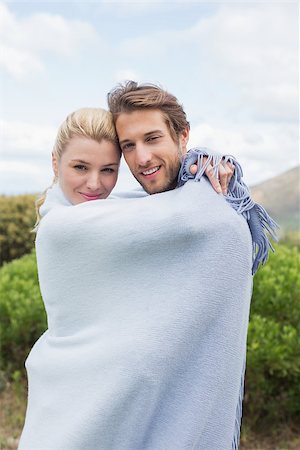 Cute smiling couple standing outside wrapped in blanket on a chilly day Stock Photo - Budget Royalty-Free & Subscription, Code: 400-07582027