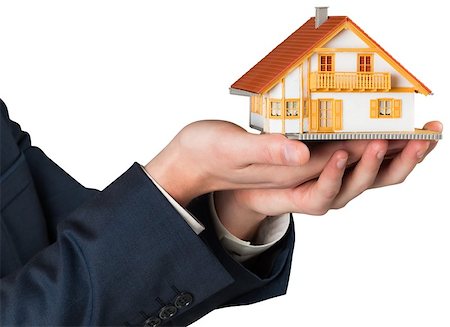 Businessman holding miniature house model on white background Stock Photo - Budget Royalty-Free & Subscription, Code: 400-07582312