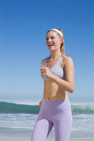 simsearch:400-07581190,k - Sporty happy blonde jogging on the beach on a sunny day Photographie de stock - Aubaine LD & Abonnement, Code: 400-07582415