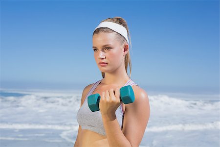 simsearch:400-07581190,k - Sporty focused blonde lifting dumbbell on the beach on a sunny day Photographie de stock - Aubaine LD & Abonnement, Code: 400-07582419