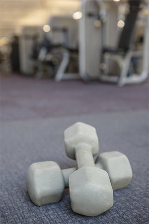 Grey dumbbells on the weights room floor at the gym Stock Photo - Budget Royalty-Free & Subscription, Code: 400-07582886