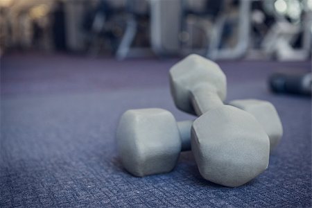 Grey dumbbells on the weights room floor at the gym Stock Photo - Budget Royalty-Free & Subscription, Code: 400-07582887