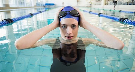 simsearch:400-07583094,k - Fit swimmer in the pool smiling at camera at the leisure center Stock Photo - Budget Royalty-Free & Subscription, Code: 400-07583035