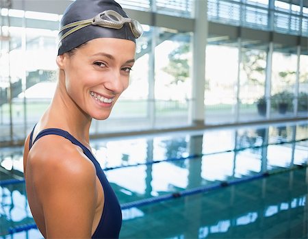 simsearch:400-07583094,k - Pretty swimmer smiling at camera by the pool at the leisure center Stock Photo - Budget Royalty-Free & Subscription, Code: 400-07583037
