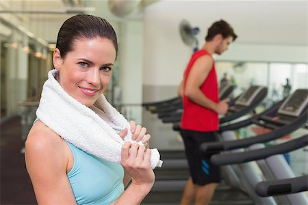 Smiling brunette with towel over shoulders at the gym Stock Photo - Budget Royalty-Free & Subscription, Code: 400-07583206