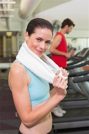 Smiling brunette with towel over shoulders at the gym Stock Photo - Budget Royalty-Free & Subscription, Code: 400-07583207