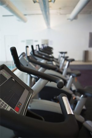swimming pool exercise bikes - Row of cross trainer machines at the leisure center Stock Photo - Budget Royalty-Free & Subscription, Code: 400-07583280