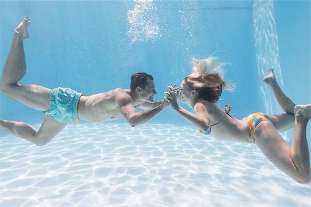 skinny man long hair - Cute couple kissing underwater in the swimming pool on their holidays Stock Photo - Budget Royalty-Free & Subscription, Code: 400-07583454
