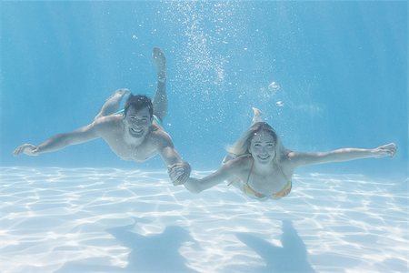 skinny man long hair - Cute couple smiling at camera underwater in the swimming pool on their holidays Stock Photo - Budget Royalty-Free & Subscription, Code: 400-07583460